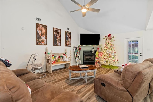 living room with ceiling fan, light hardwood / wood-style flooring, and high vaulted ceiling