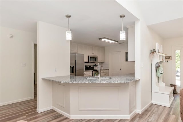 192 Bay View Dr, Daphne, AL 36526 - kitchen with stainless steel appliances, light wood-style flooring, and light stone counters