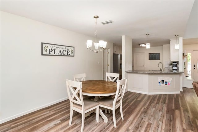 192 Bay View Dr, Daphne, AL 36526 - dining room featuring a chandelier and wood finished floors