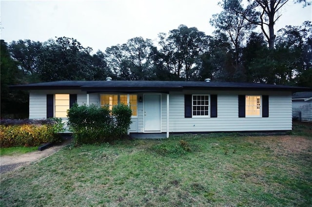 ranch-style home with a front lawn