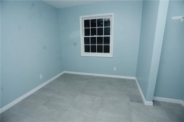 empty room featuring baseboards
