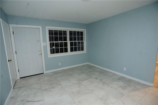 interior space featuring marble finish floor and baseboards