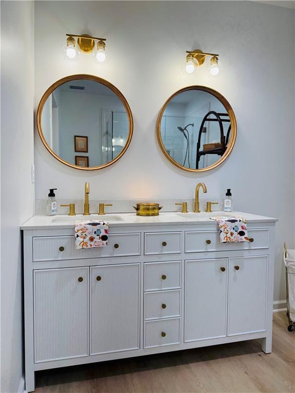 bathroom with vanity and hardwood / wood-style floors