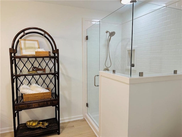 bathroom featuring an enclosed shower and hardwood / wood-style floors