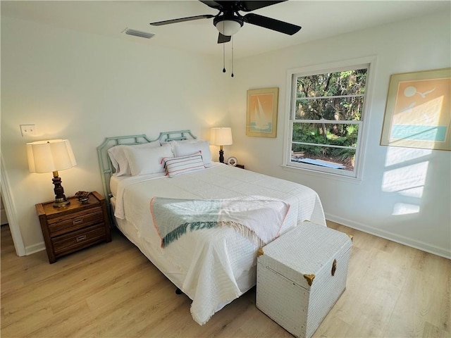 bedroom with light hardwood / wood-style floors and ceiling fan