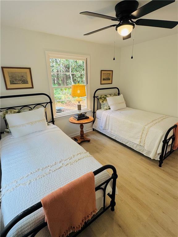 bedroom featuring wood-type flooring and ceiling fan