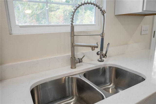 room details with white cabinetry and sink