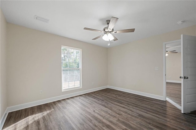 unfurnished room with dark hardwood / wood-style floors and ceiling fan