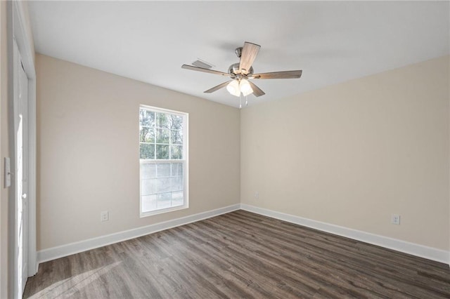 spare room featuring dark hardwood / wood-style floors and ceiling fan