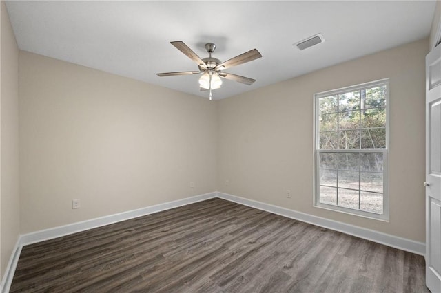 empty room with ceiling fan and dark hardwood / wood-style flooring