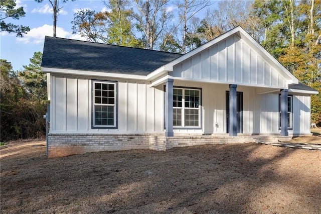 back of property featuring covered porch