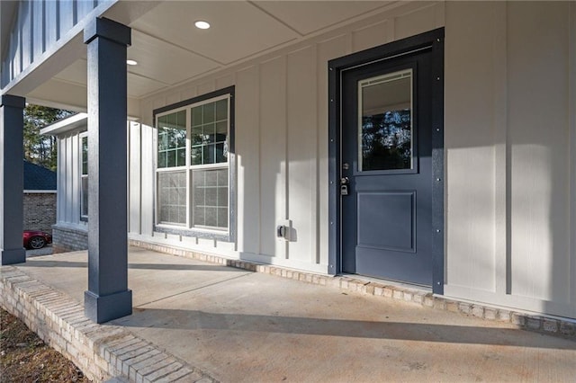 view of exterior entry featuring covered porch