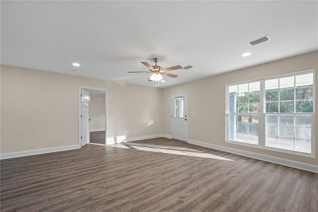 unfurnished room featuring ceiling fan and dark hardwood / wood-style flooring