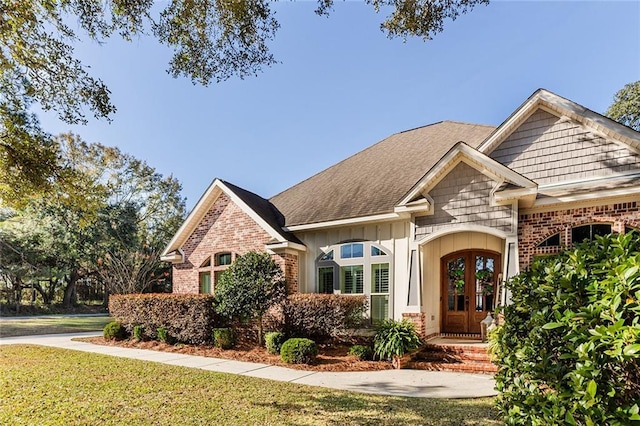 view of front of property with french doors and a front lawn