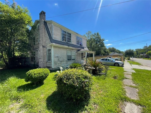 1008 Miami St, Mobile, AL 36604 - view of side of home with a chimney and a lawn