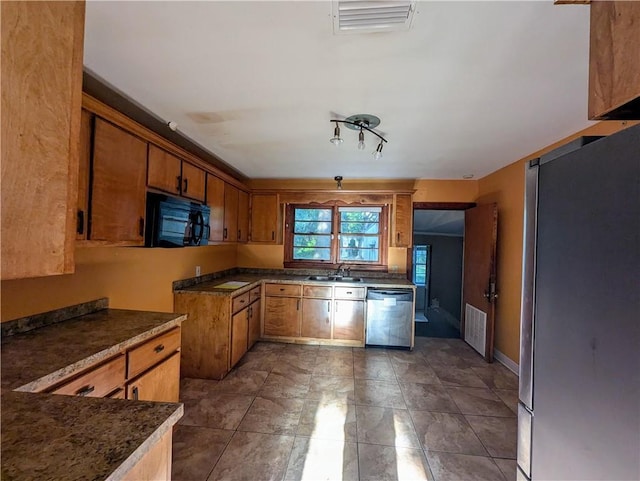 1151 Navco Rd, Mobile, AL 36605 - kitchen with appliances with stainless steel finishes, a sink, brown cabinets, and dark countertops