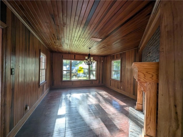 1151 Navco Rd, Mobile, AL 36605 - unfurnished dining area featuring a chandelier, wooden ceiling, wooden walls, wood finished floors, and baseboards