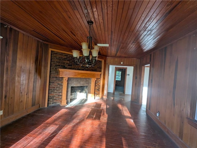 1151 Navco Rd, Mobile, AL 36605 - unfurnished living room with wood walls, wooden ceiling, hardwood / wood-style flooring, a chandelier, and a fireplace