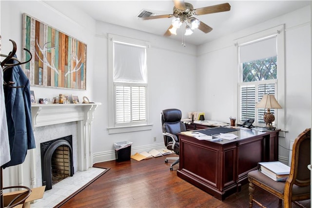 office featuring ceiling fan, a healthy amount of sunlight, and hardwood / wood-style flooring