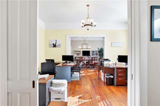 home office featuring a chandelier and light wood-type flooring