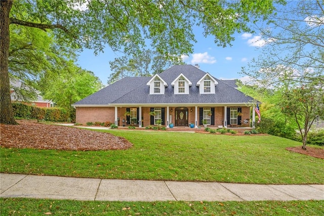 view of front of property with a porch and a front yard