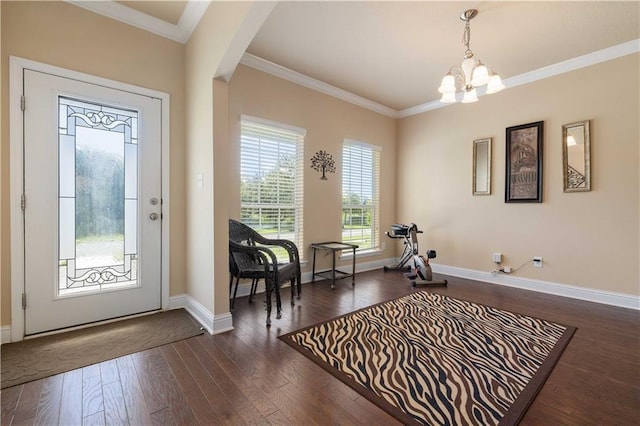 entryway with arched walkways, a chandelier, baseboards, ornamental molding, and dark wood finished floors