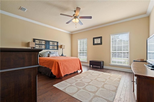 bedroom featuring baseboards, crown molding, visible vents, and dark wood-style flooring