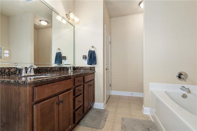 full bathroom with a garden tub, a sink, baseboards, tile patterned floors, and double vanity