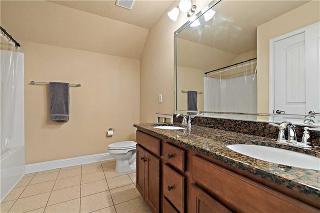 bathroom featuring tile patterned flooring, a sink, lofted ceiling, and double vanity