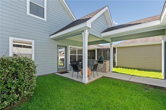 rear view of house with a lawn and a patio