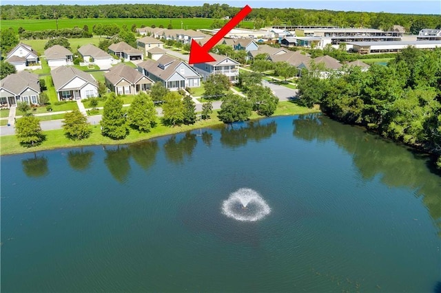 bird's eye view featuring a water view and a residential view