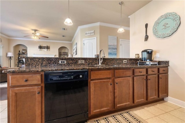 kitchen with a sink, black dishwasher, brown cabinets, dark stone counters, and decorative light fixtures