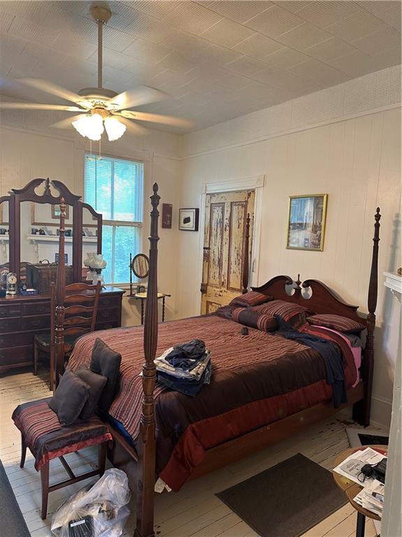 bedroom featuring ceiling fan and light hardwood / wood-style floors