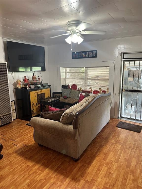 living room featuring hardwood / wood-style floors and ceiling fan