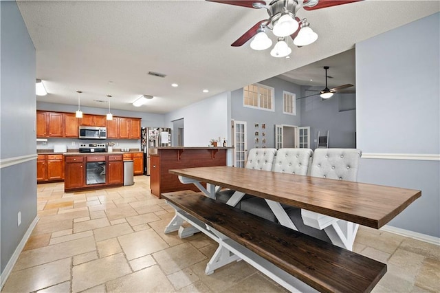 dining area featuring a textured ceiling and ceiling fan