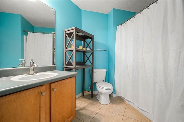 bathroom featuring tile patterned floors, toilet, a textured ceiling, and vanity