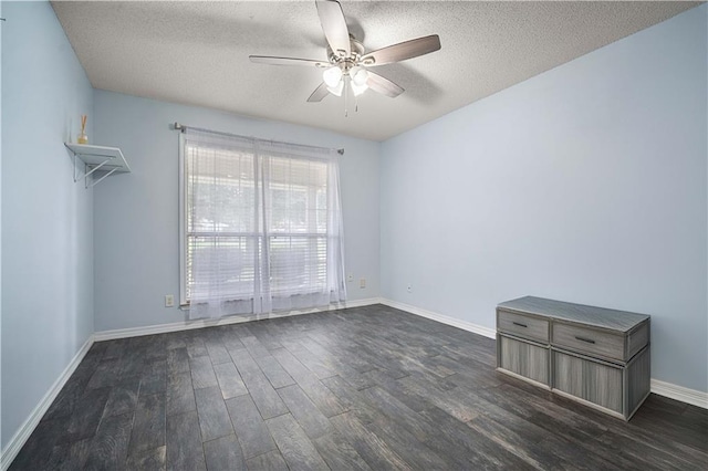 empty room featuring ceiling fan, dark hardwood / wood-style flooring, and a textured ceiling