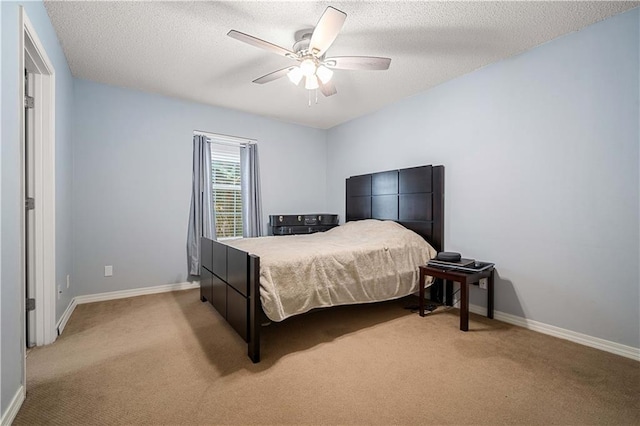 bedroom featuring ceiling fan, light carpet, and a textured ceiling