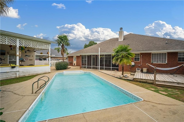 view of pool featuring a patio and a wooden deck