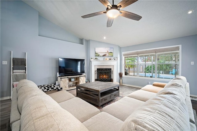 living room with light wood-type flooring, ceiling fan, and vaulted ceiling