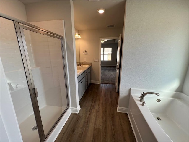 bathroom featuring vanity, hardwood / wood-style flooring, and separate shower and tub