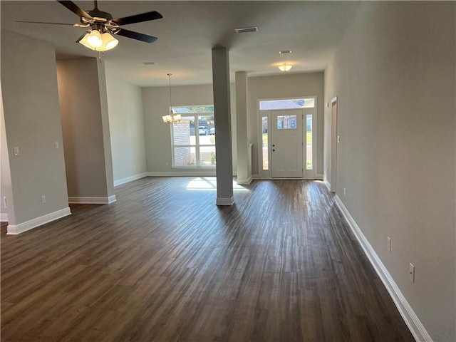 entrance foyer with ceiling fan with notable chandelier and dark hardwood / wood-style floors