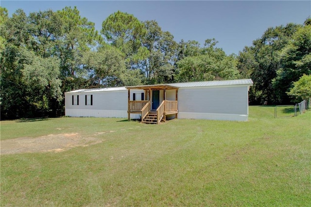 manufactured / mobile home featuring metal roof and a front yard