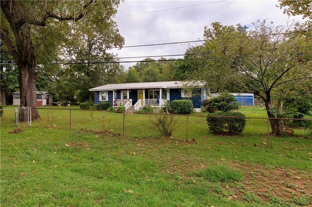 view of front of property with a front yard, covered porch, and a fenced front yard