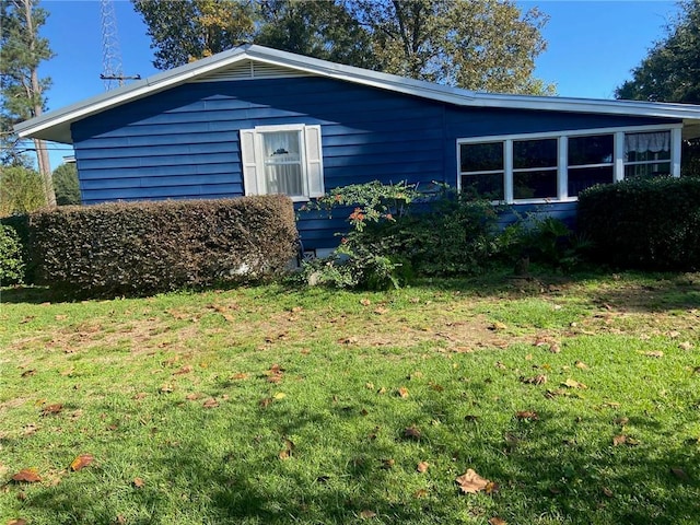 view of property exterior featuring a lawn