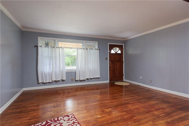 foyer entrance featuring wood finished floors, baseboards, and ornamental molding