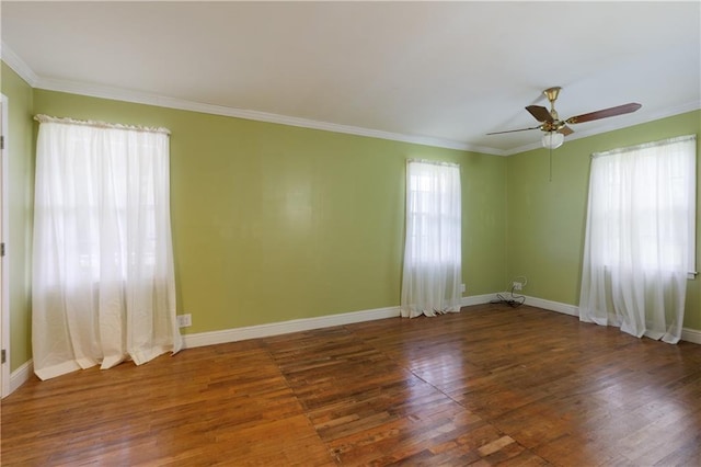 spare room with crown molding and wood finished floors
