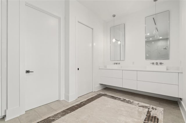 bathroom featuring tile patterned floors, vanity, and a shower