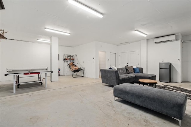 basement featuring stainless steel fridge and an AC wall unit