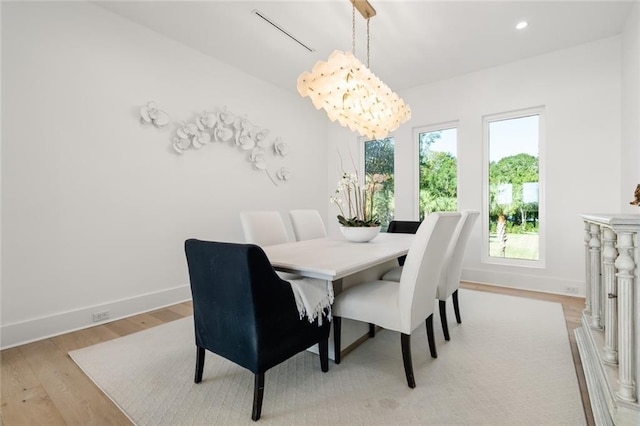 dining room featuring an inviting chandelier and light hardwood / wood-style flooring